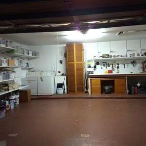 After: Garage-Free standing bi-fold doors around heater; Shelves with matching clear bins; tool/workbench area; paint the floor